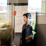 A photo of me standing in front of a whiteboard